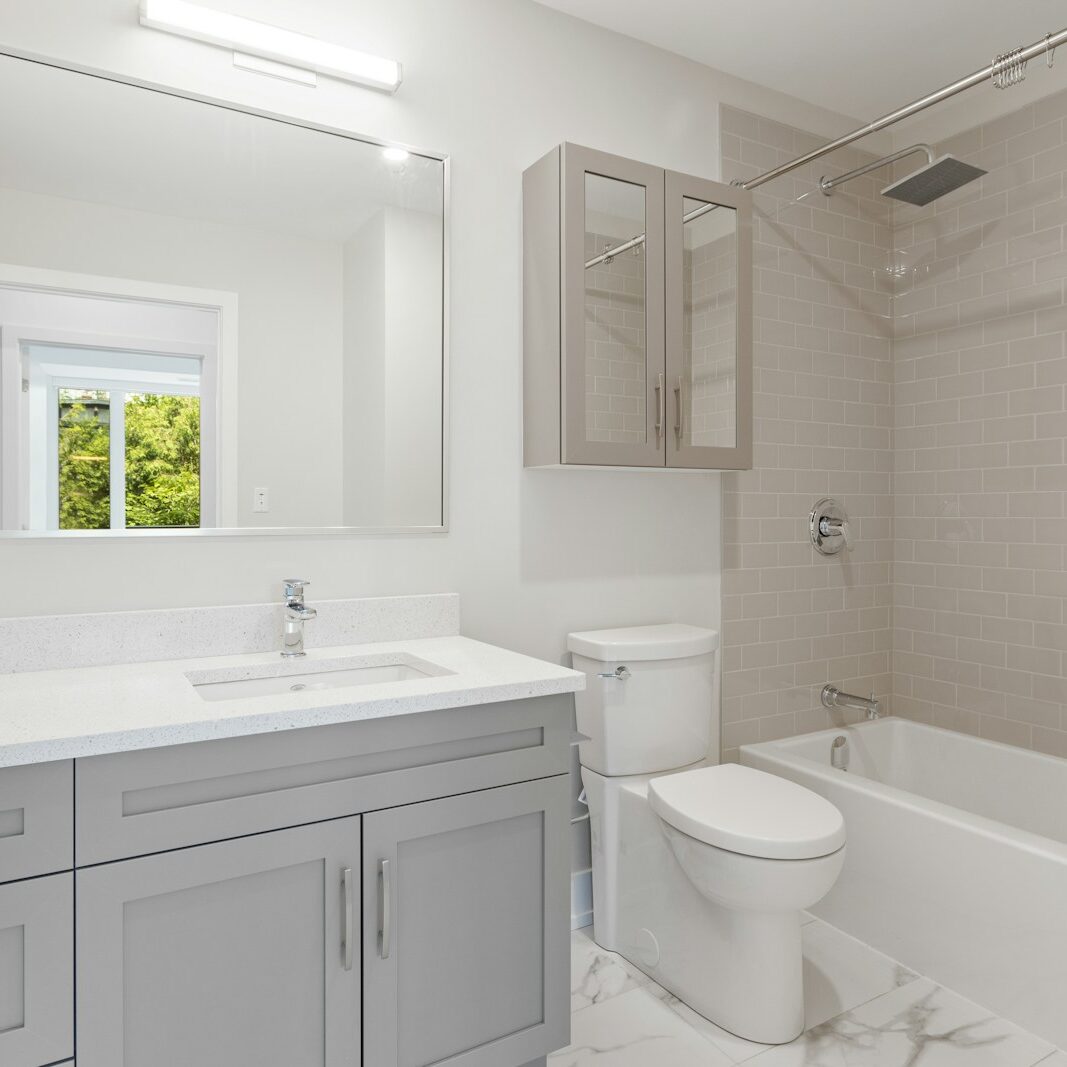 white ceramic toilet bowl near white ceramic sink